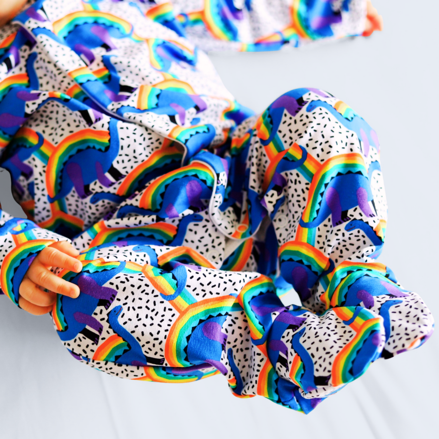 RAINBOW DINO SLEEPSUIT . Up to 18 Months