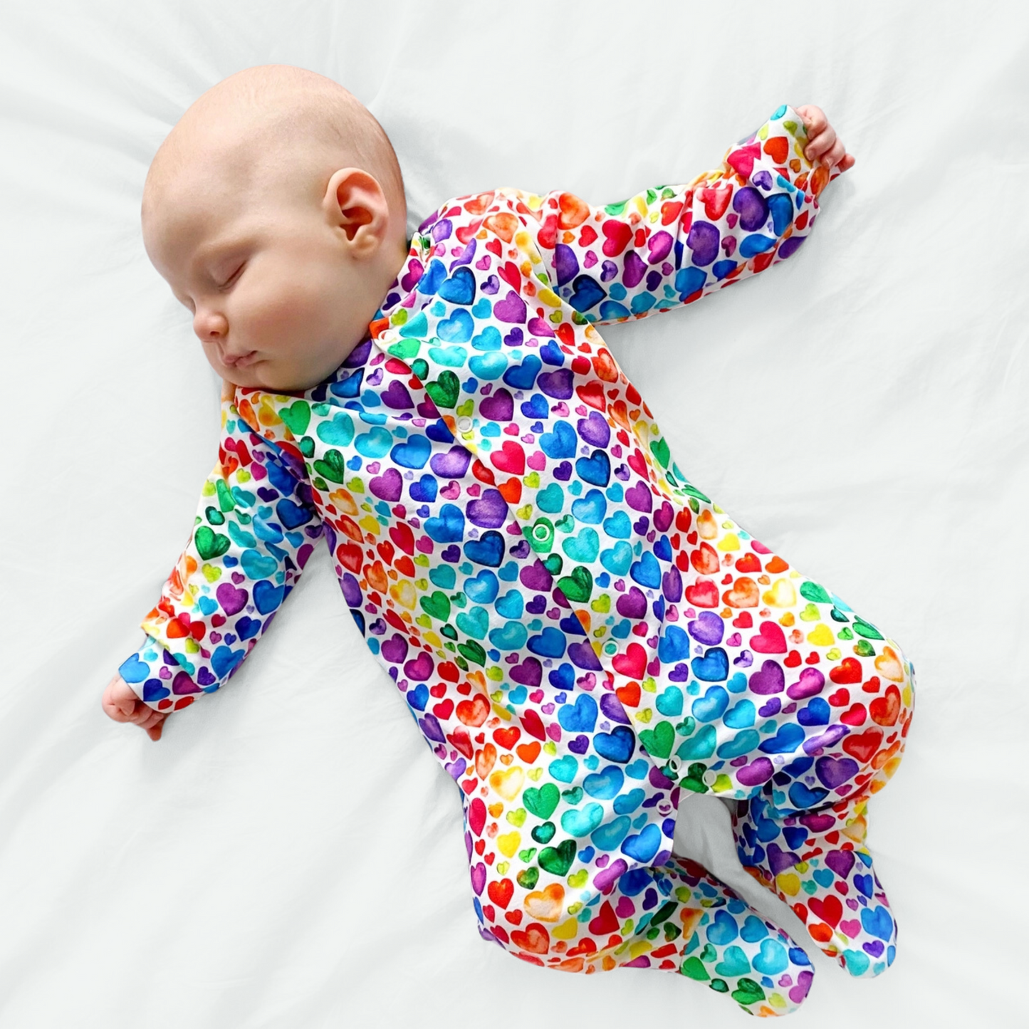 RAINBOW HEART SLEEPSUIT . Up to 18 Months